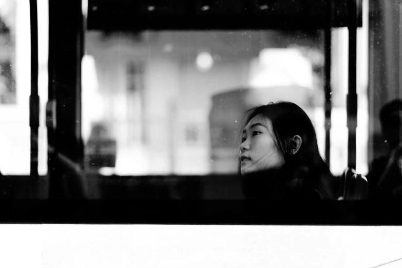 a black and white po of a woman waiting for her bus