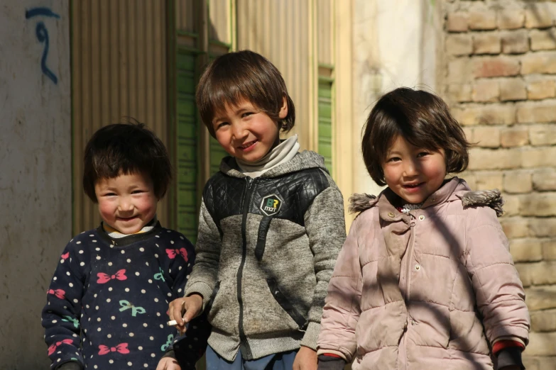 three young children who are posing for the camera