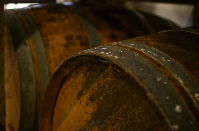 a bunch of wooden barrels lined up near each other