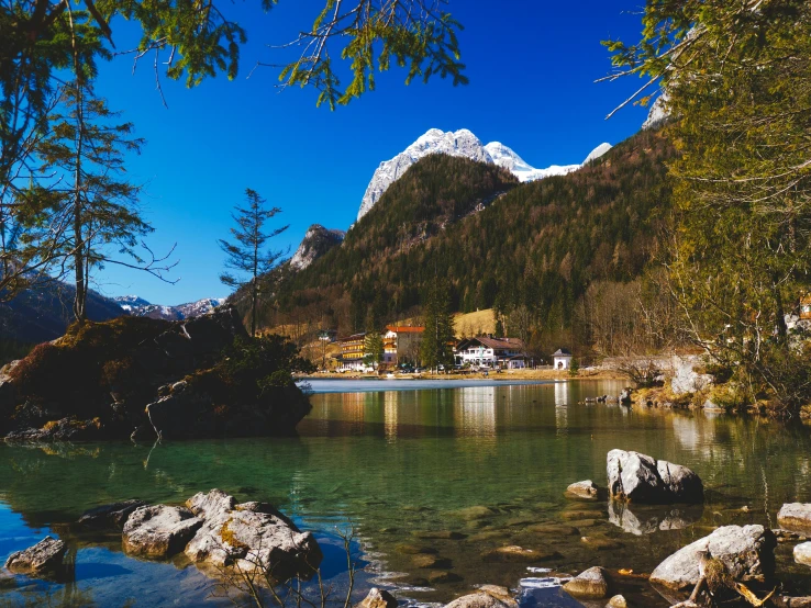 a lake surrounded by mountains in the daytime