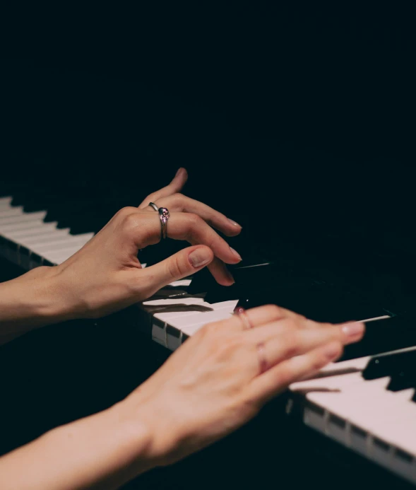hands are typing on a piano with one hand