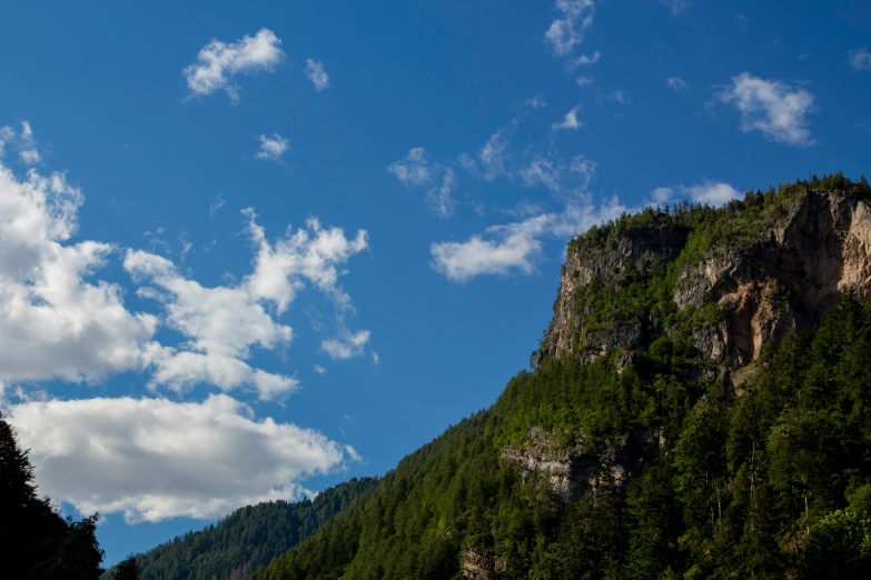 clouds roll across the sky over a mountain