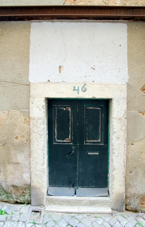 two door with numbers on a side of a building