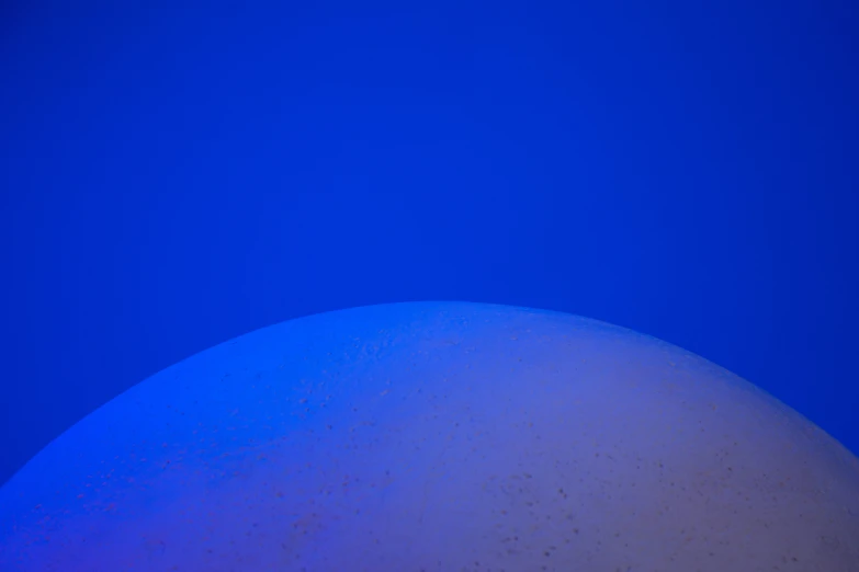 a blue sky with a very large ball in the middle
