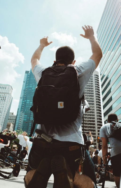 a man with a backpack walks down a city street