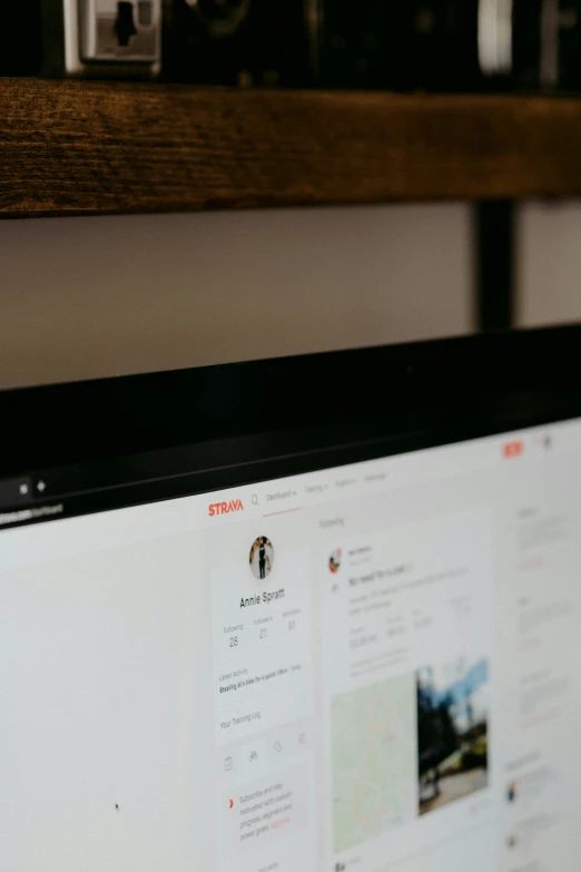 a computer monitor sitting on top of a wooden shelf