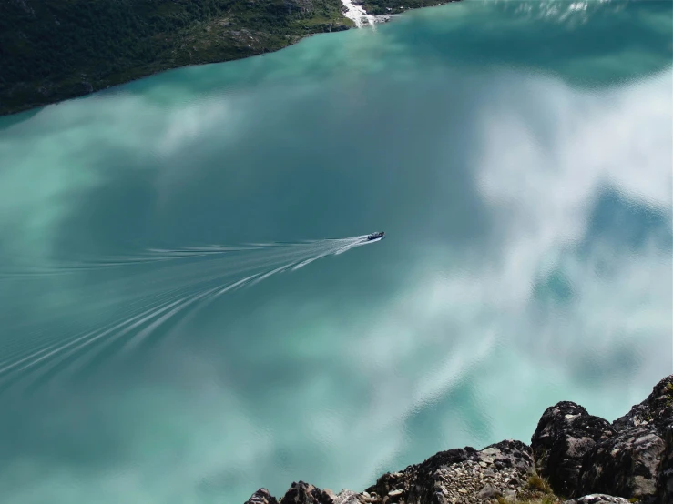 a jet boat speeds through the blue water of the lake