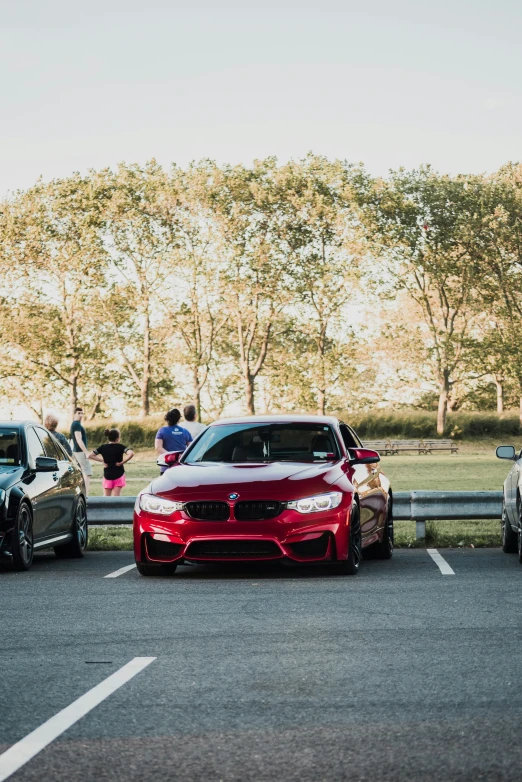 three bmws and two silver cars in a parking lot