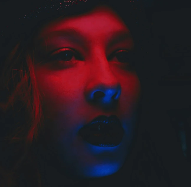 a woman with blue and red lights on her face