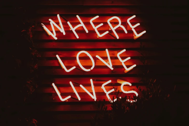 a neon sign with words written across it