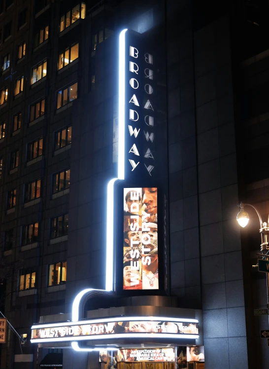 a theater building with some neon lights on it