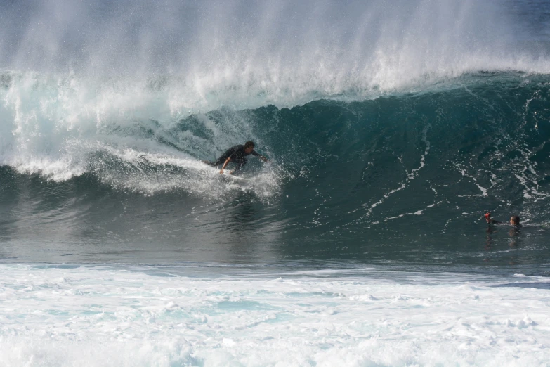 a man riding a wave in the middle of a surfboard ride