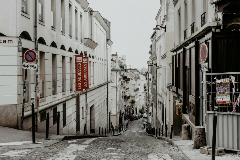 an empty street with several different signs on the buildings