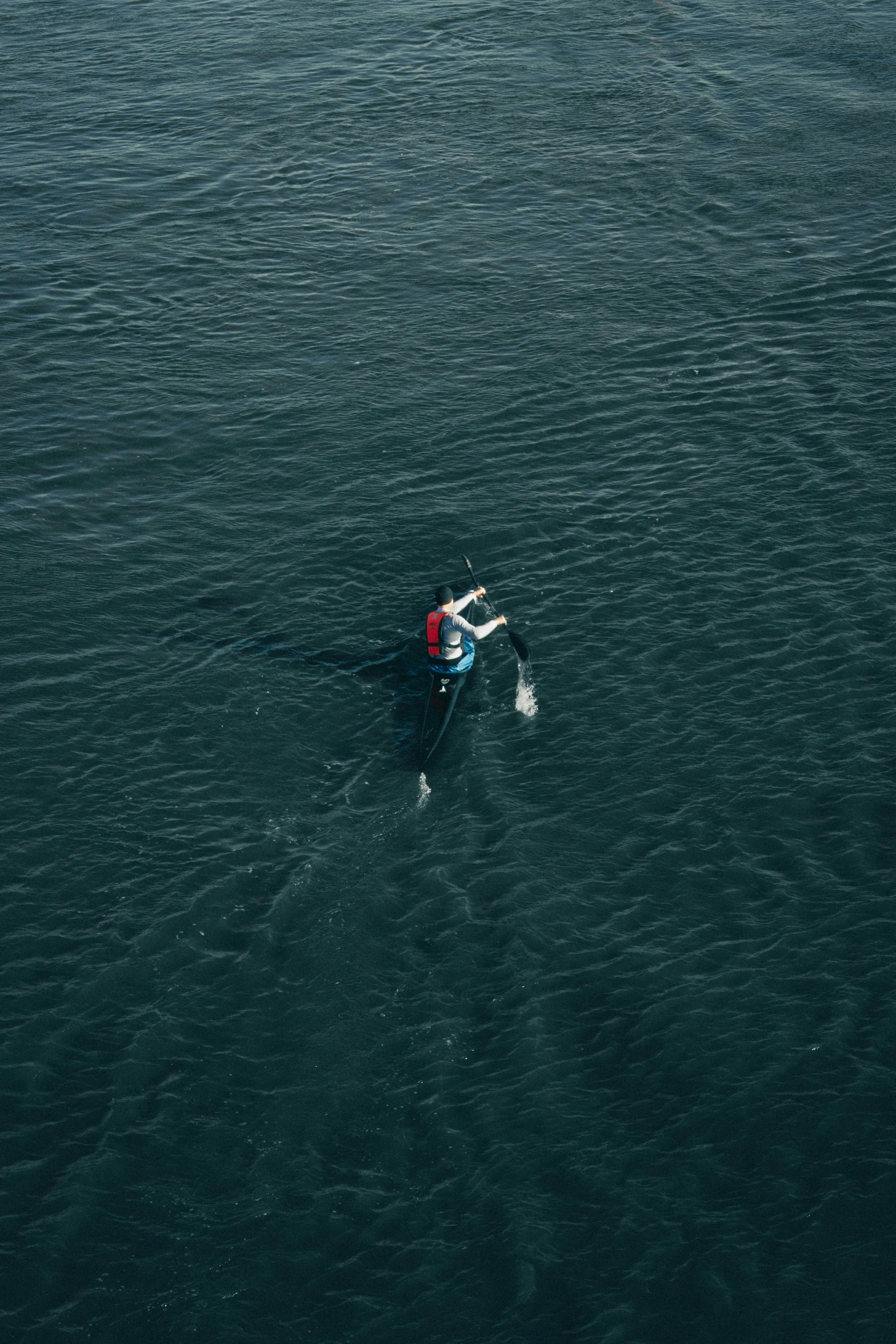 a lone boat is floating across the water