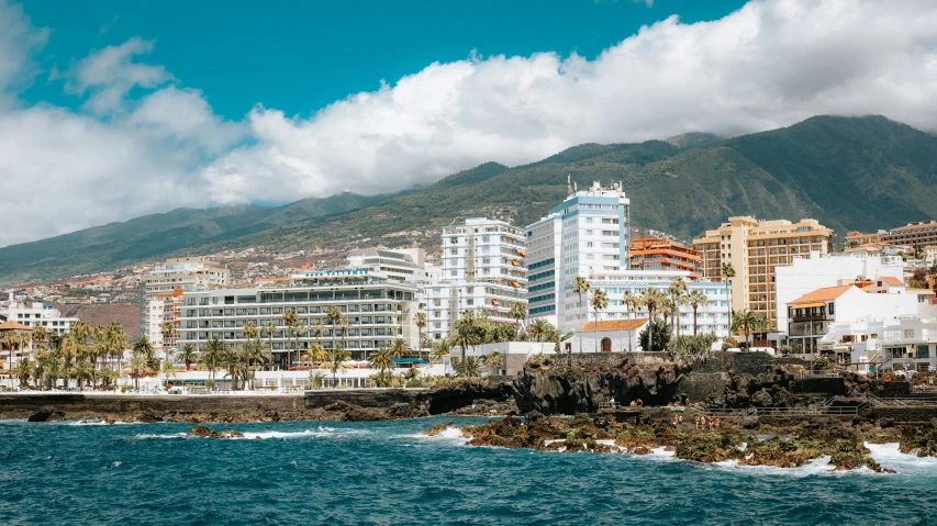 a view of the ocean from a beach in a city