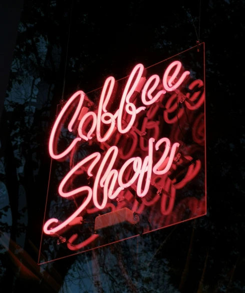 a sign on the side of the road that reads coffee shop