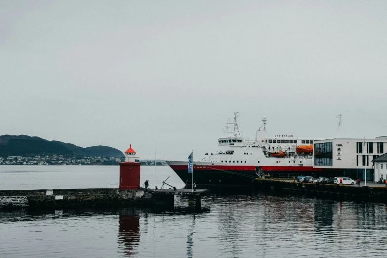 a large ship sits in the ocean on a very cloudy day