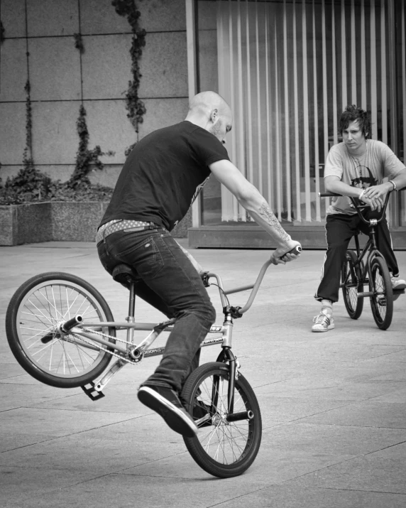 a man on a bicycle in the middle of a street