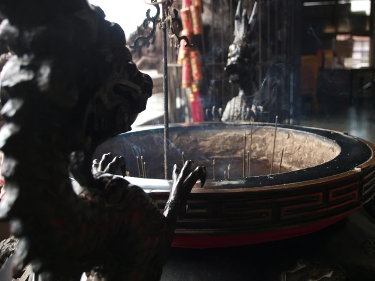 a statue is set on the ground near a water fountain