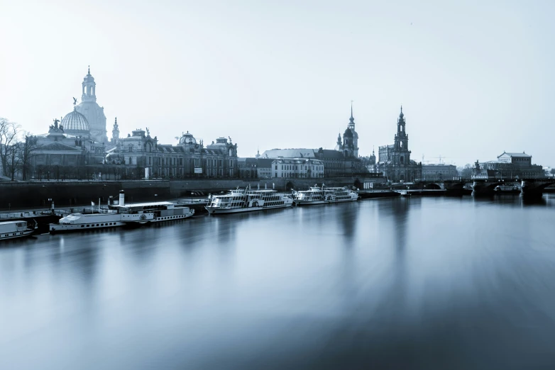 a waterway filled with lots of boats floating next to tall buildings