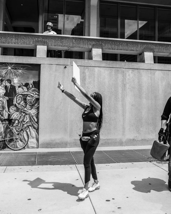 the two people are playing with kites on the street