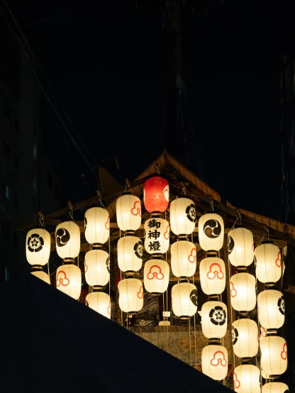 an array of lanterns are lit with orange lights
