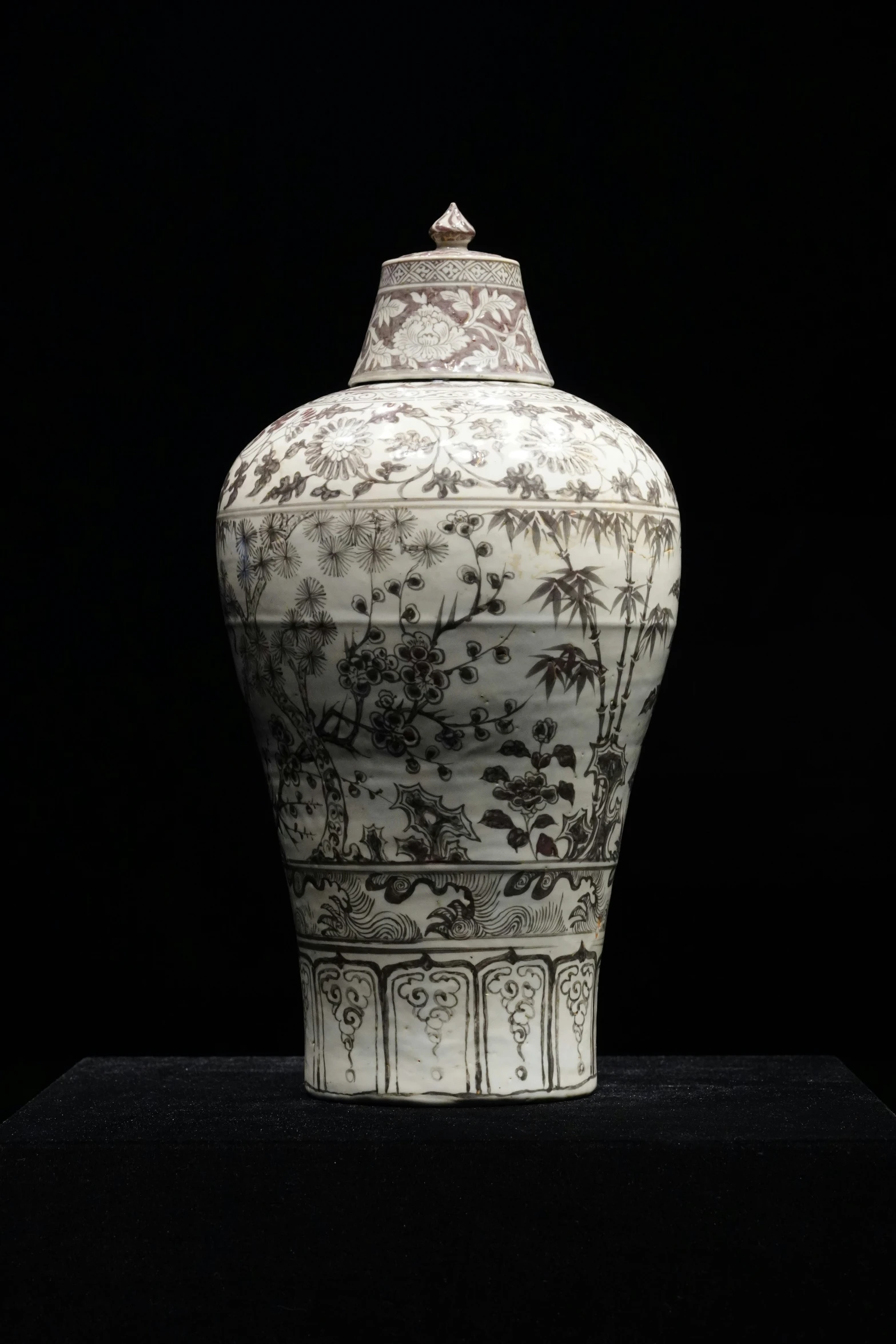 a large white vase with black design on it