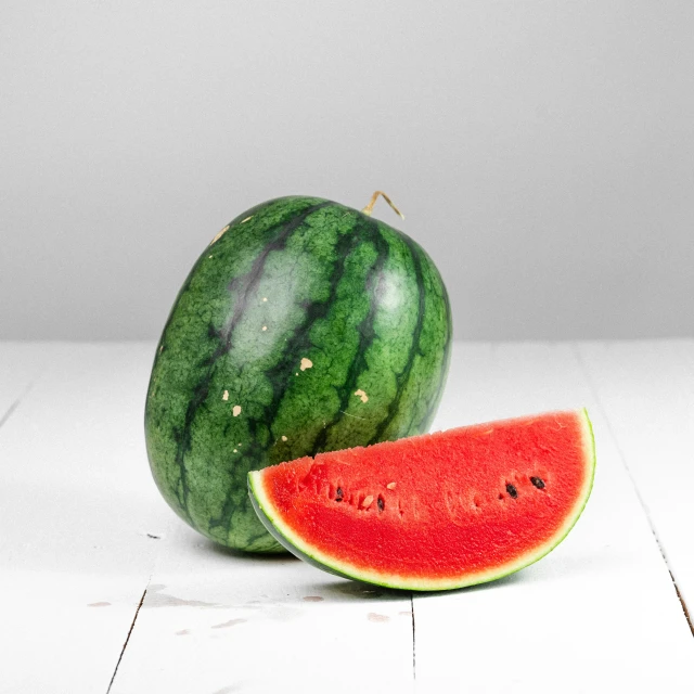 a cut in half watermelon with the remaining one