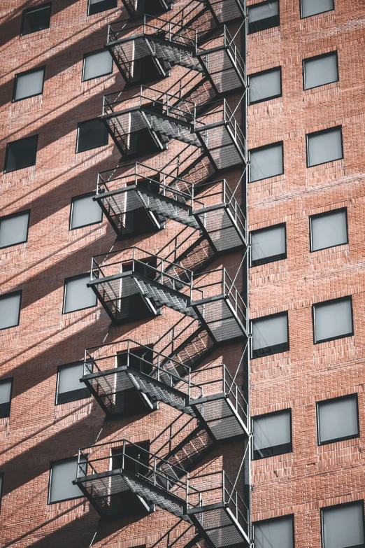 the fire escape is on the side of a brick building