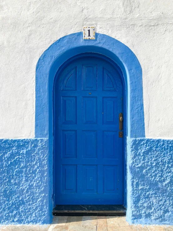 an entrance to an old building with blue paint