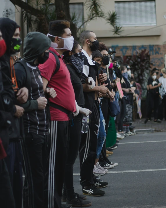 a long line of people wearing face masks