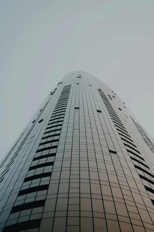 an upward view looking up at the side of a tall building