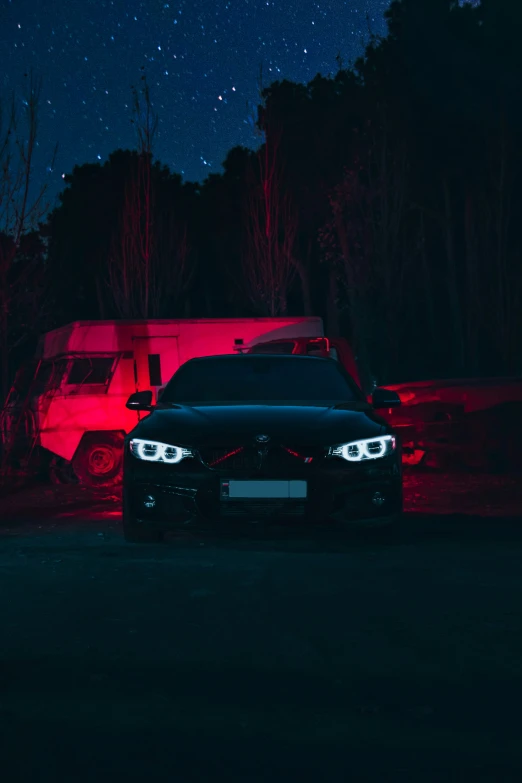 a car parked on the side of a road in the dark