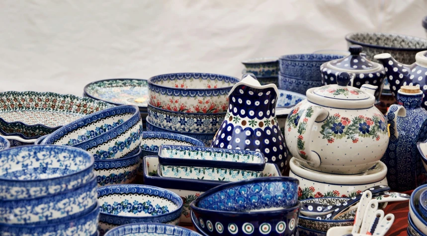 some blue dishes and plates on top of a white table