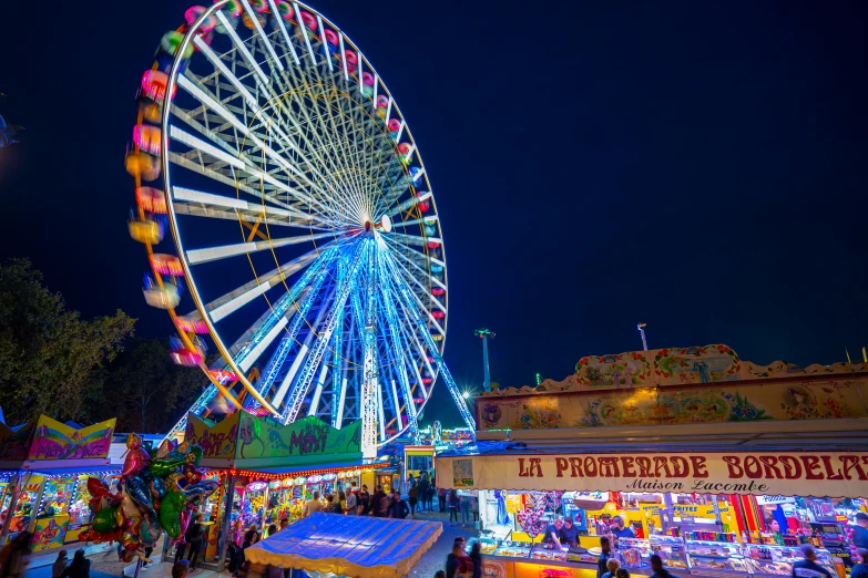 a ferris wheel is seen in this brightly lit po