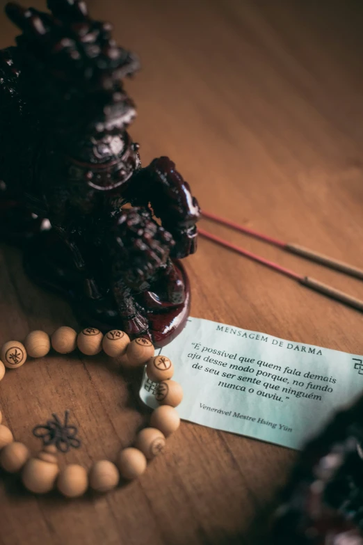 two wooden beads on a table with a tag