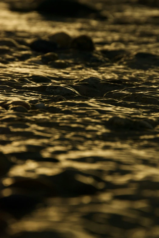 a small wave hitting on rocks in the water