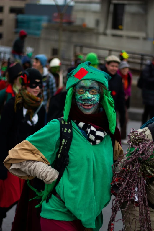 a person with a green and red face painted