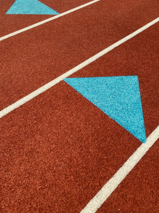 a blue triangle is in the center of a red floor