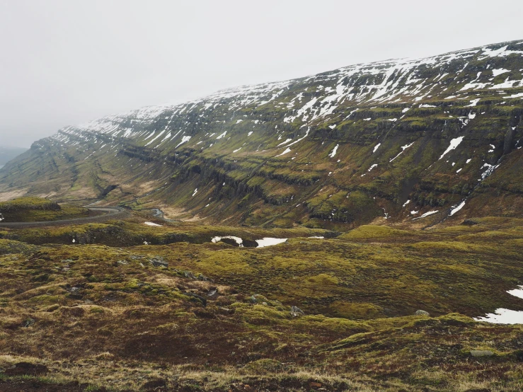 the mountains have been covered with snow and green vegetation