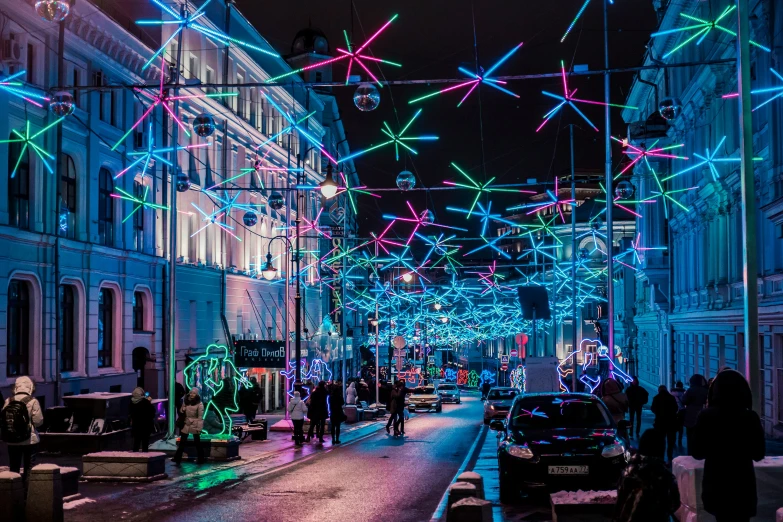 the city street is lit up with christmas lights