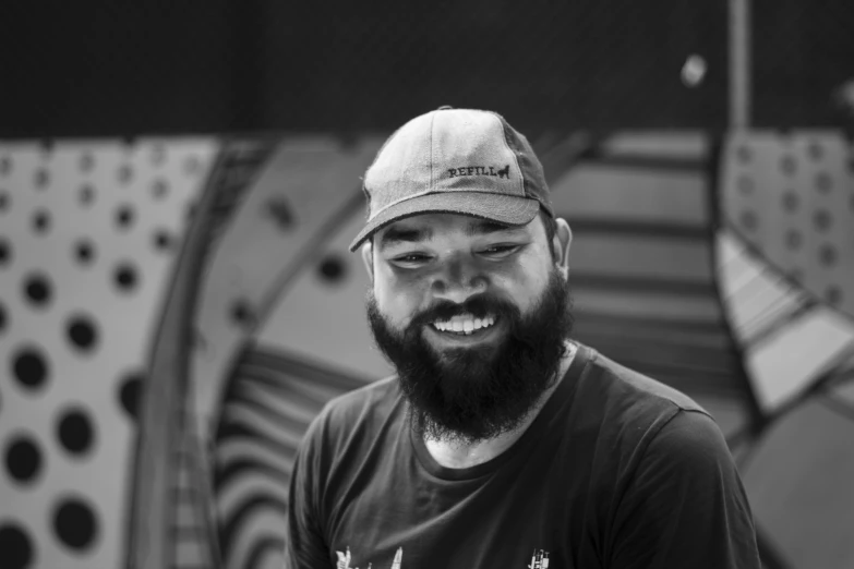 a man with a beard wearing a baseball hat