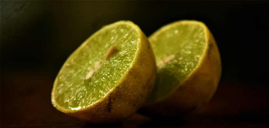 two lemon halves are cut in half on a table