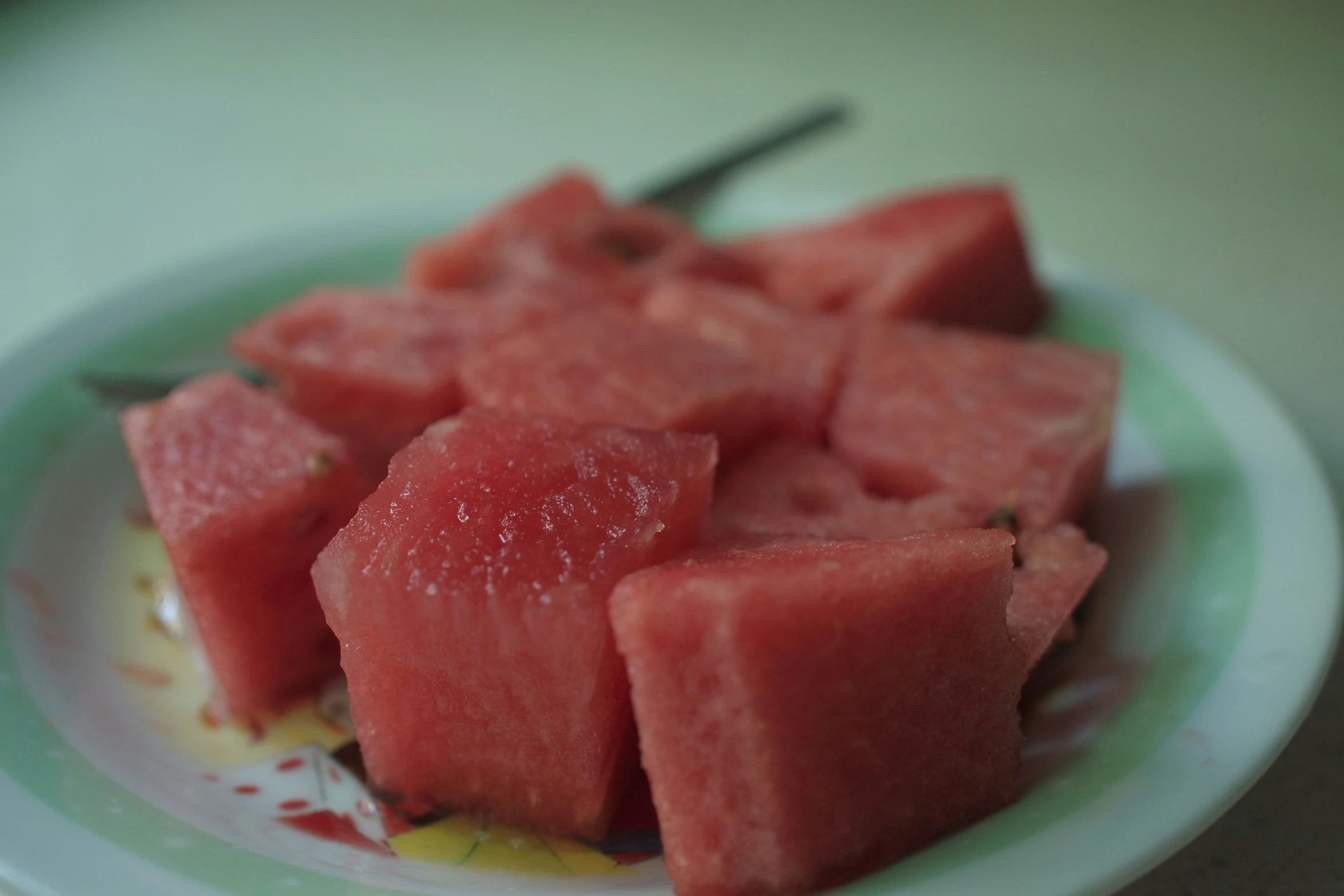 a white plate topped with pieces of watermelon