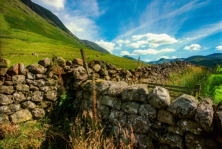 rock wall in the mountains near an old stone bridge