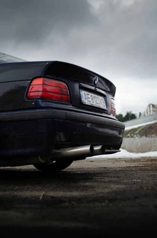 black car parked with dark clouds in background