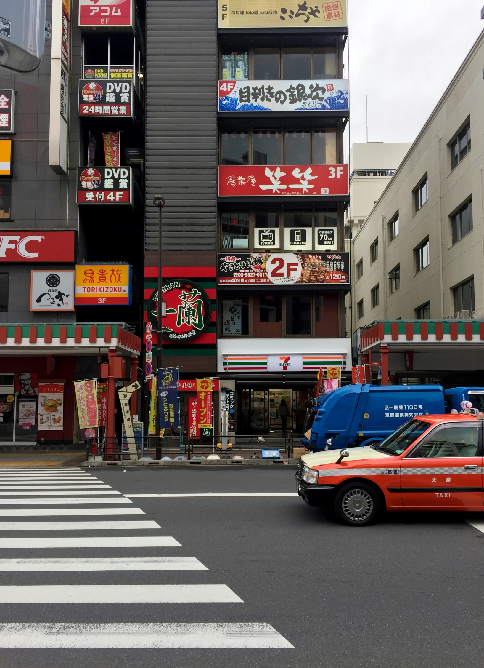 a van is in front of some buildings on the street