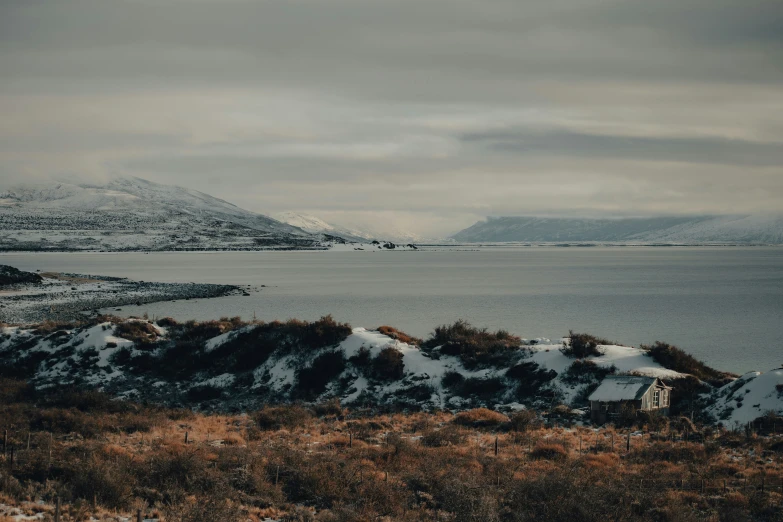 the snow covered mountains and the ocean are viewed from high above