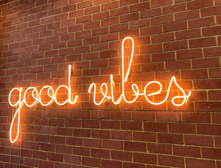 neon sign on brick wall advertising a restaurant