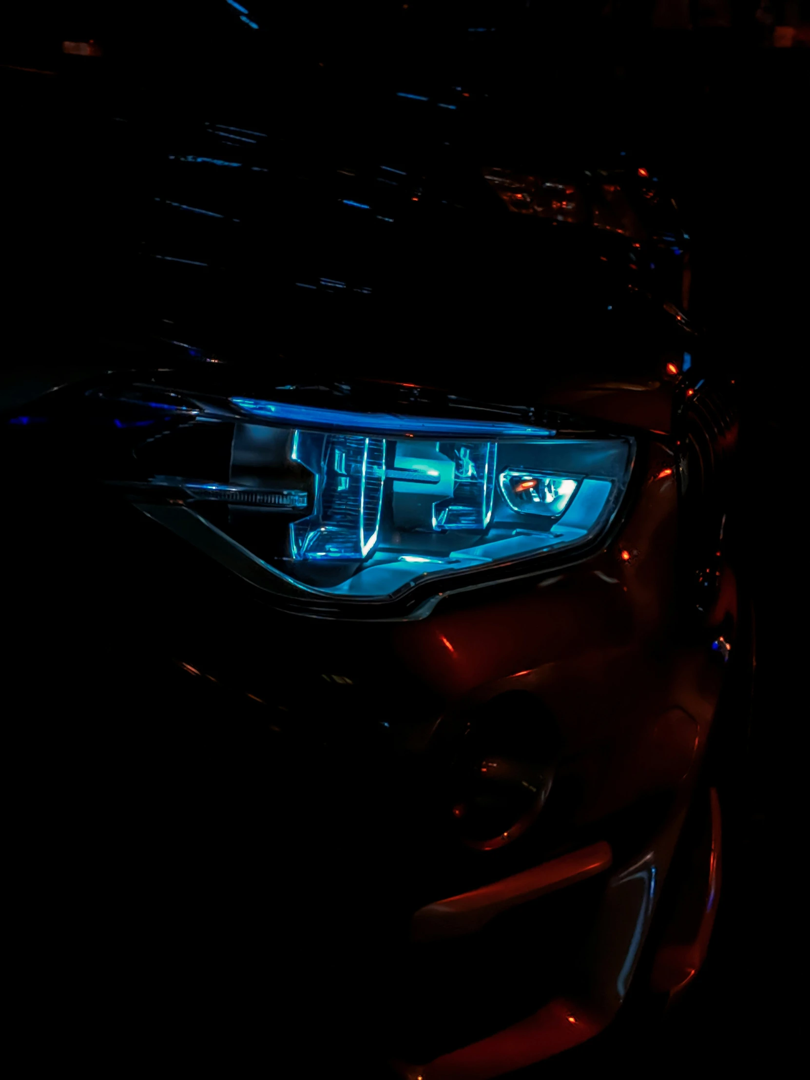 a car's headlight is shown in the dark